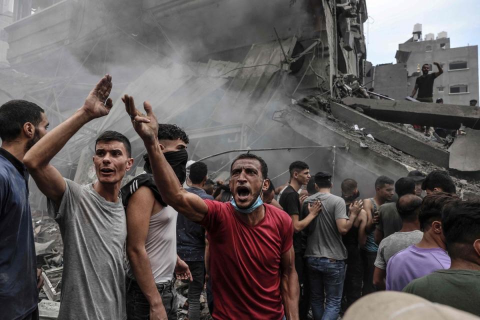 Palestinians search for survivors after an Israeli airstrike on buildings in the refugee camp of Jabalia in the Gaza Strip (AFP via Getty Images)