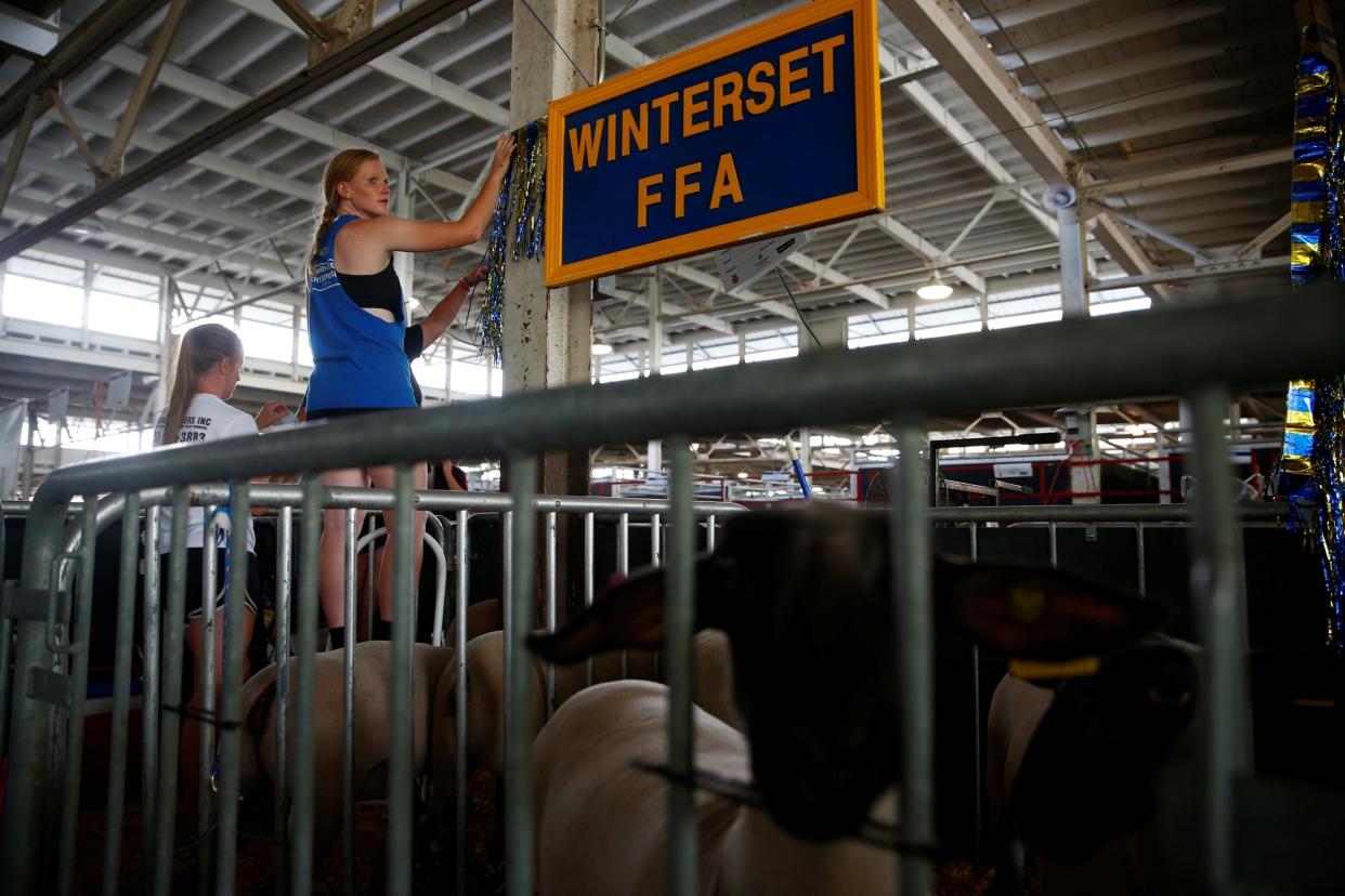 People preparing for the Iowa State Fair. The agricultural show's ability to attract top politicians every year is testament to the power of the farming industry in the US: Reuters