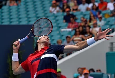 Mar 31, 2019; Miami Gardens, FL, USA; John Isner of the United States serves to Roger Federer of Switzerland during the men's finals at Miami Open Tennis Complex. Steve Mitchell-USA TODAY Sports