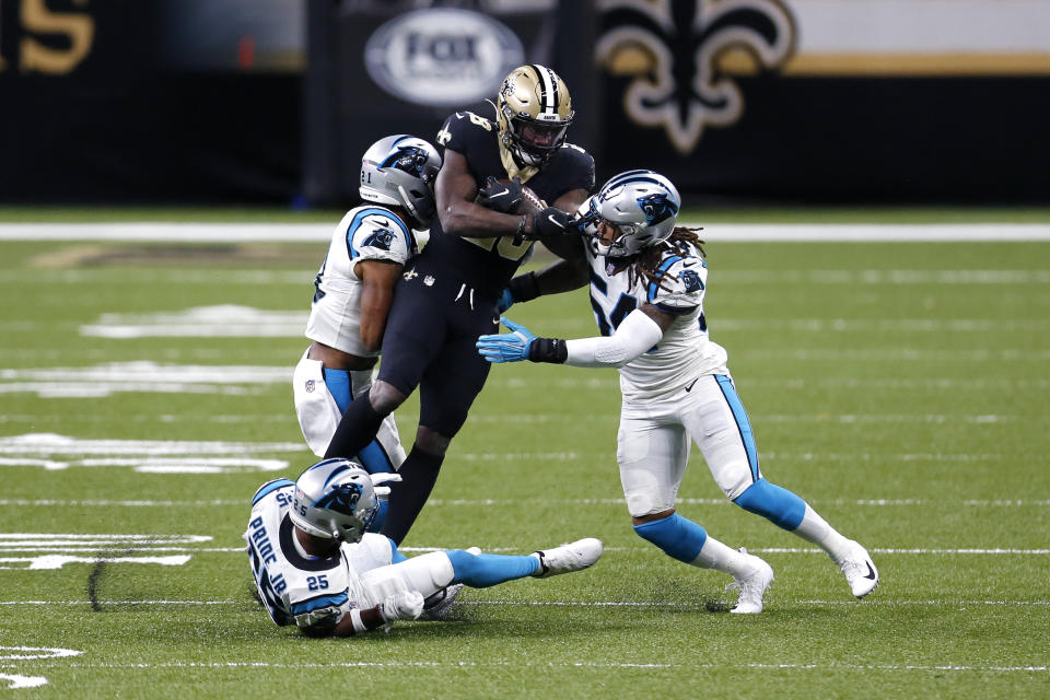 New Orleans Saints running back Latavius Murray (28) is stopped by Carolina Panthers outside linebacker Shaq Thompson (54), outside linebacker Jeremy Chinn (21) and cornerback Troy Pride (25) in the first half of an NFL football game in New Orleans, Sunday, Oct. 25, 2020. (AP Photo/Brett Duke)