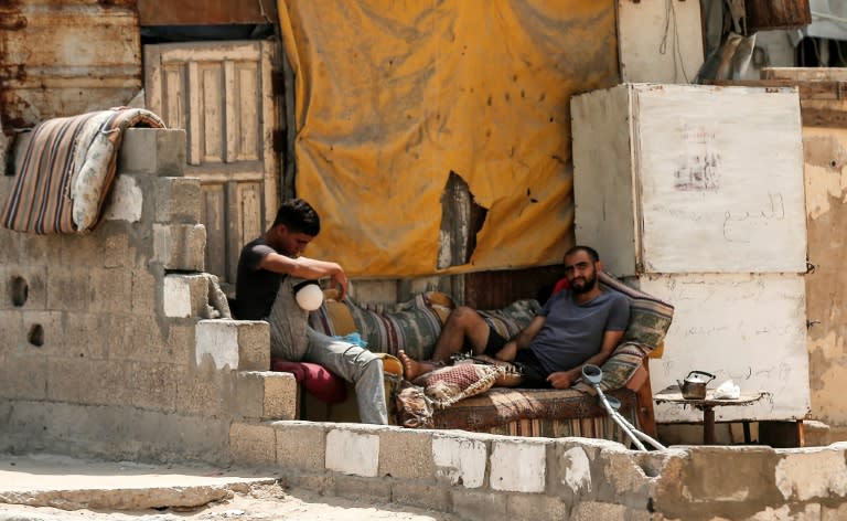 Palestinian refugees chat at the Al-Shati refugee camp, in Gaza City on September 1, 2018