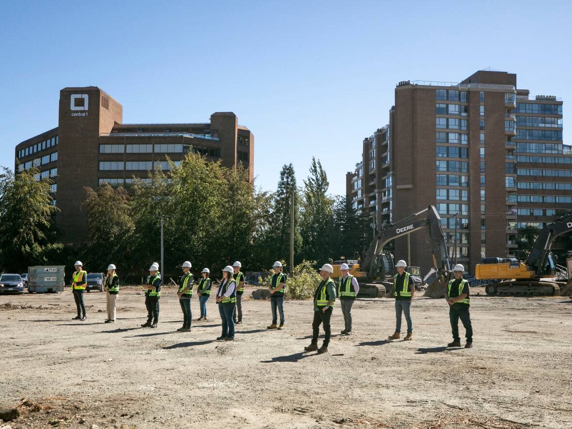 Construction crews are pictured at a ceremony breaking ground at the Squamish Nation-led Sen̓áḵw housing development near the Burrard Bridge in Vancouver on Sept. 6. (Ben Nelms/CBC - image credit)