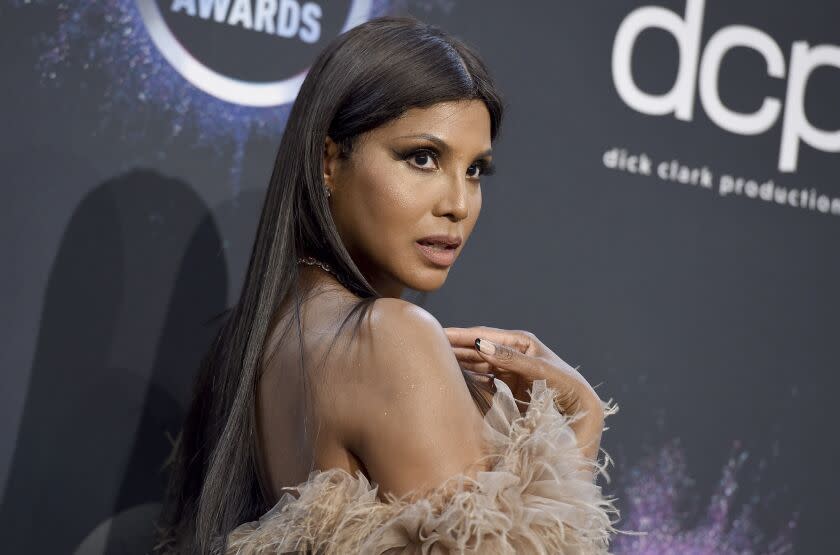 Toni Braxton in a fuzzy brown strapless dress