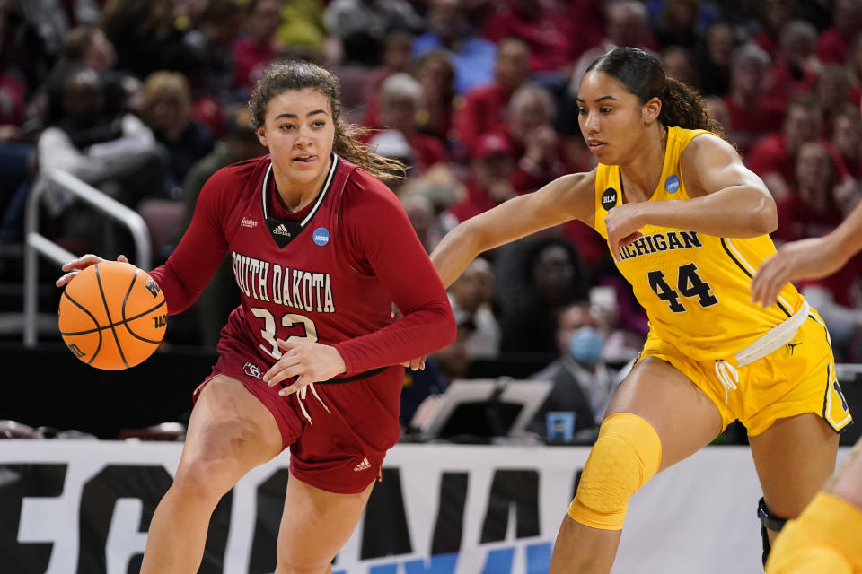 South Dakota's Kyah Watson (32) heads to the basket as Michigan's Cameron Williams (44) defends during the first half of a college basketball game in the Sweet 16 round of the NCAA women's tournament Saturday, March 26, 2022, in Wichita, Kan. (AP Photo/Jeff Roberson)