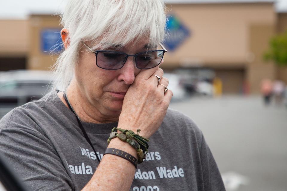 Mary Ramsbottom becomes emotional as she hands out missing persons flyers with the faces of her sister, Paula Wade, and nephew, Brandon, to people in the parking lot of the Sam’s Club parking lot in Valdosta.