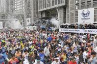 Runners fill the street at the start of the Tokyo Marathon in Tokyo, Japan