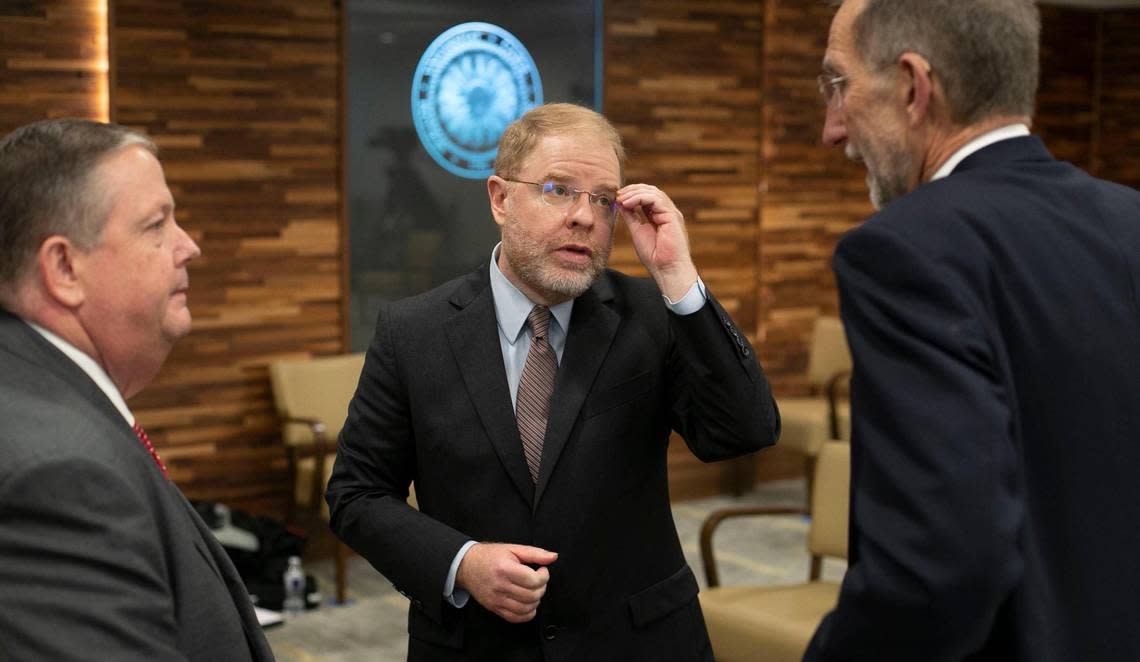 Newly elected UNC System President Peter Hans, center, talks with Randall Ramey, chairman of The Board of Governors, left, and interim President Dr. William L. Roper following his election on Friday, June 19, 2020 in Chapel Hill, N.C.