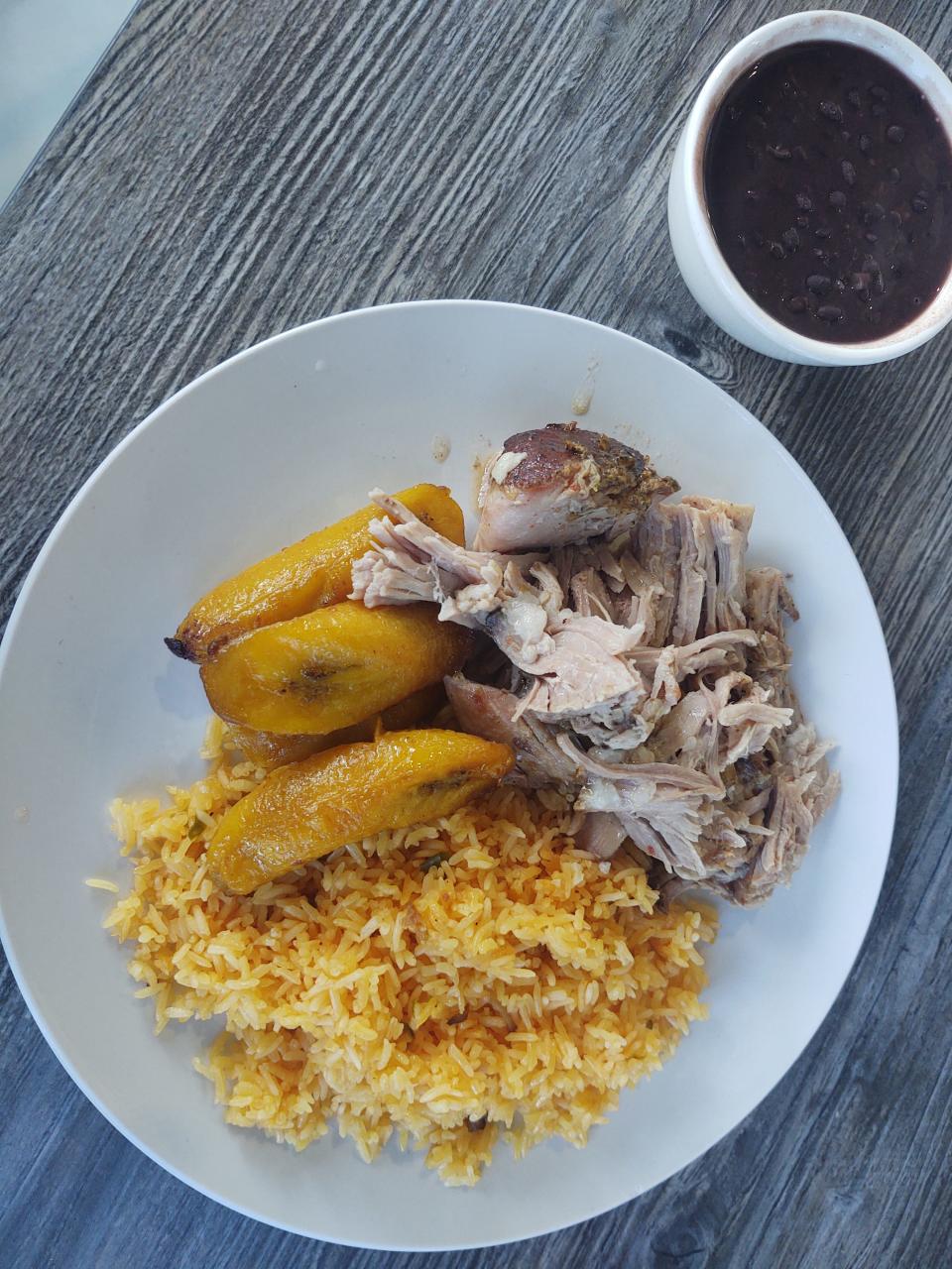 The Latin Melting Pot in Vero Beach serves succulent pork with rice and plantains on the side.