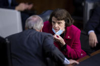 Committee chairman Sen. Lindsey Graham, R-S.C., and ranking member Sen. Dianne Feinstein, D-Calif., talk as Supreme Court nominee Amy Coney Barrett testifies during her confirmation hearing before the Senate Judiciary Committee on Capitol Hill in Washington, Tuesday, Oct. 13, 2020. (Brendan Smialowski/Pool via AP)