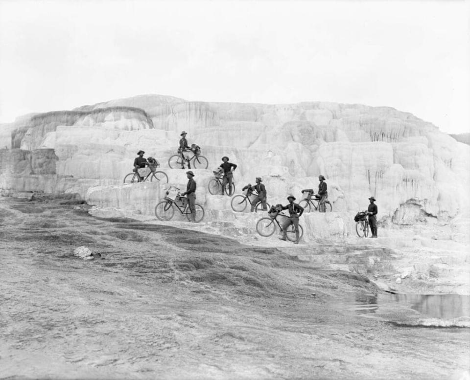 In this archive photo, members of the Buffalo Soldier Corps of the 25th Infantry pose at Minerva Terrace, Mammoth Hot Springs, Yellowstone National Park. The Yellowstone trip was one of several that the Soldier Corps took before embarking on the 1,900-mile journey to Missouri. (Photo by F. Jay Haynes, 1896. Montana Historical Society Research Center, Haynes Foundation Photograph Collection, H-3614.)