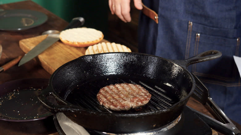 cooking burger with cast iron pan