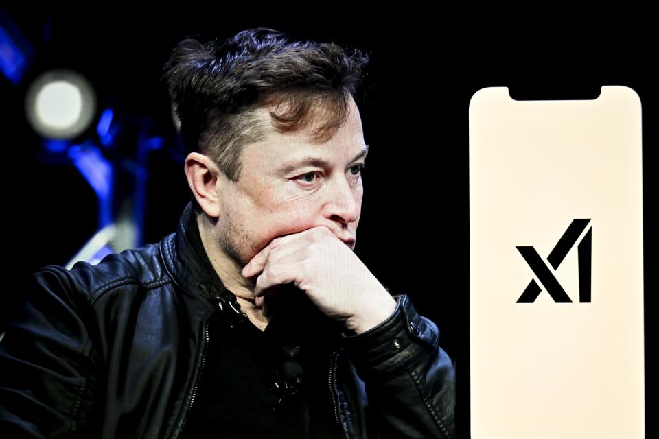 Elon Musk next to xAI's logo on a phone