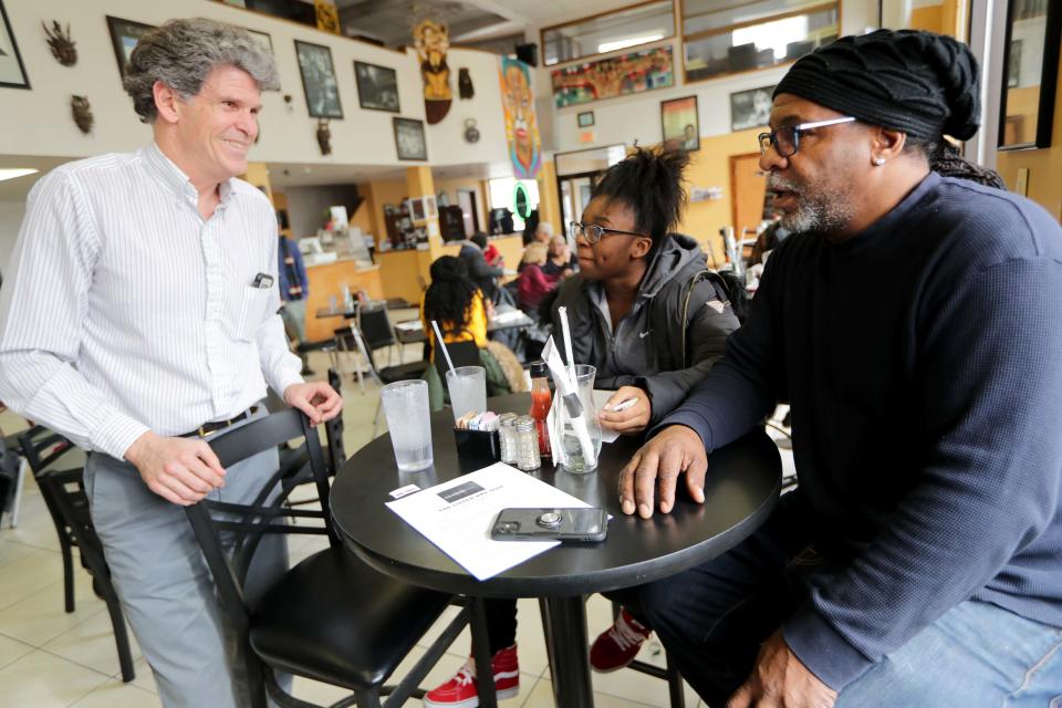 Pete Sullivan, Milwaukee Journal Sentinel deputy features editor, talks to customers Greg D. and his daughter Etana A. during the Listen MKE Open Newsroom event at Coffee Makes You Black on North Teutonia Avenue in Milwaukee in early 2020. The collaborative effort by the Ideas Lab, WUWM, Milwaukee PBS, and the Milwaukee Public Library, sought to improve how we provide information, hear about stories we haven't told, and better understand what is most important to people. 
(Photo: Mike De Sisti / Milwaukee Journal Sentinel)