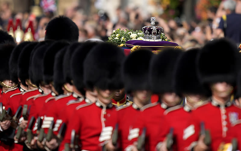 The Imperial State Crown rests on the coffin of Queen Elizabeth II during the procession from Buckingham Palace to Westminster Hall in London, on Sept. 14. <em>Associated Press/Frank Augstein, Pool</em>