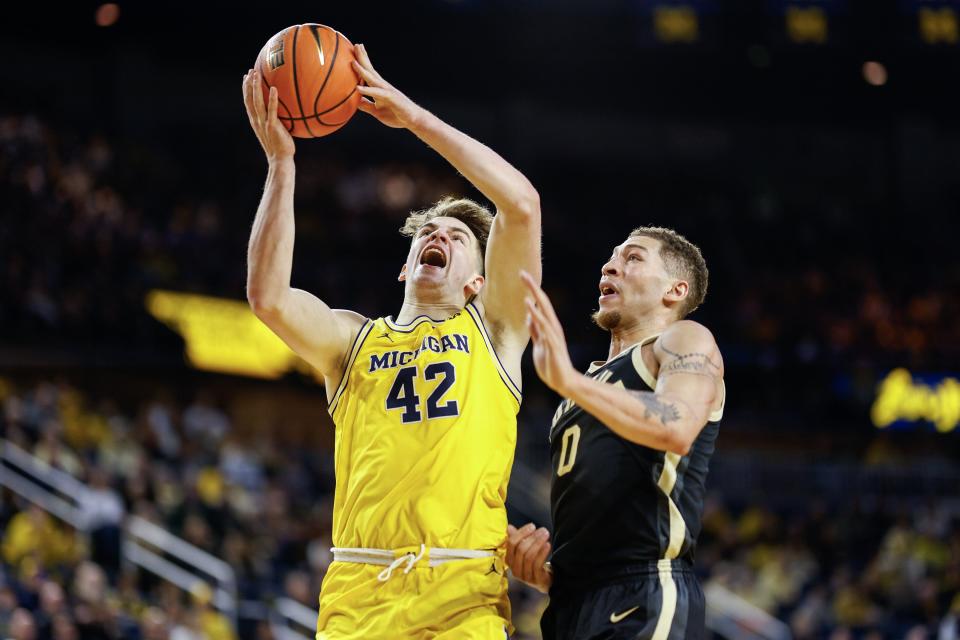Will Tschetter #42 of the Michigan Wolverines goes up for a layup against Mason Gillis of the Purdue Boilermakers in the first half of a game at Crisler Arena on Sunday, Feb. 25, 2024, in Ann Arbor, Michigan.