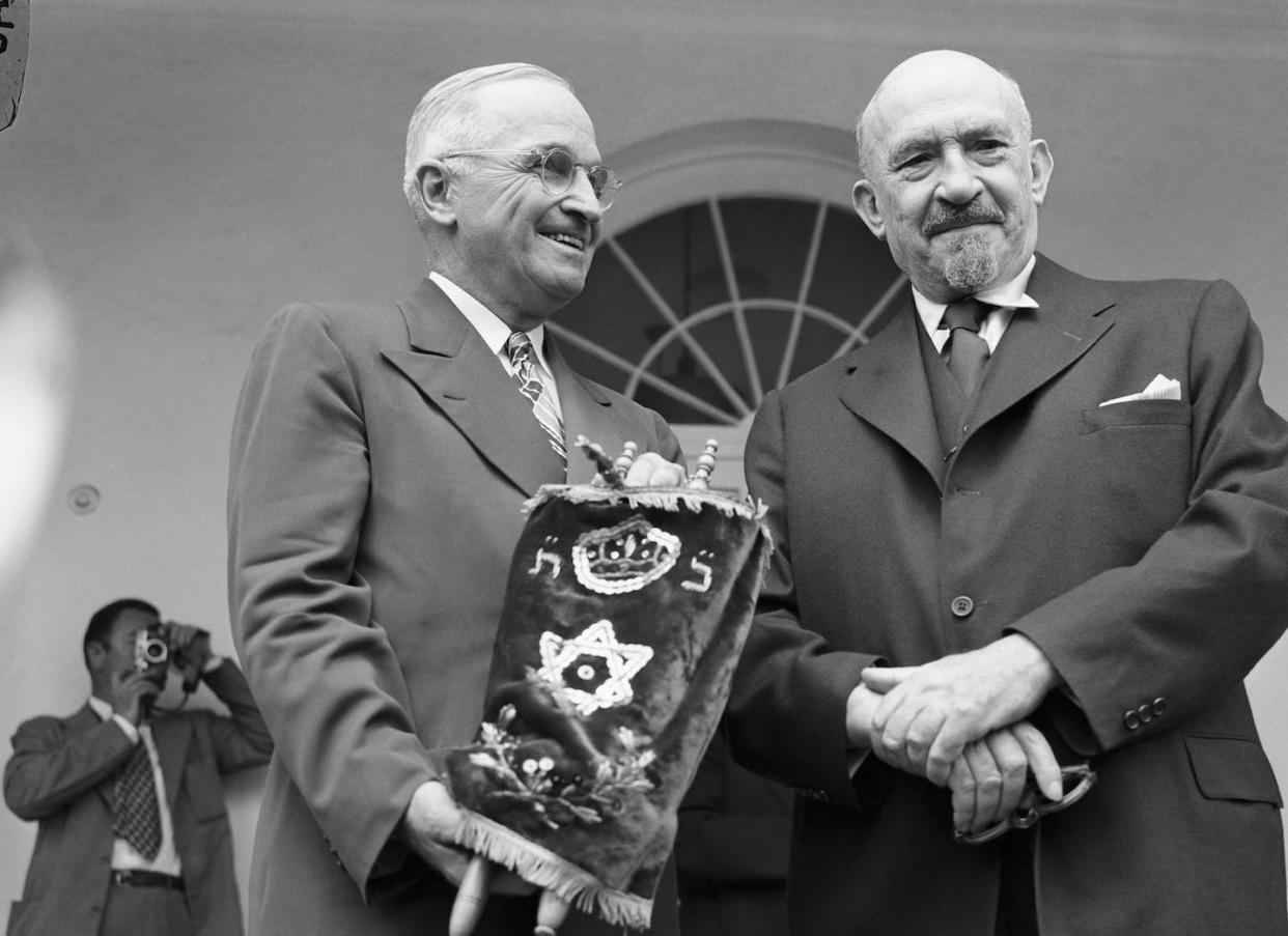 U.S. President Harry Truman holds a Torah given to him by Chaim Weizmann, the first president of Israel, in May 1948. <a href="https://www.gettyimages.com/detail/news-photo/washington-dc-president-truman-holds-the-torah-or-sacred-news-photo/514876256" rel="nofollow noopener" target="_blank" data-ylk="slk:Bettmann via Getty Images;elm:context_link;itc:0;sec:content-canvas" class="link ">Bettmann via Getty Images</a>