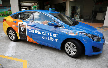 A ComfortDelgro taxi carrying an Uber advertisement is pictured in Singapore March 26, 2018. REUTERS/Edgar Su