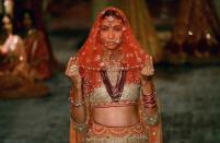 <p>A model presents a creation by Indian fashion designer Tarun Tahiliani during the FDCI India Couture week 2016 in New Delhi on July 21, 2016. </p>