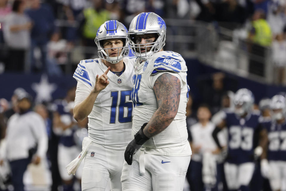 FILE - Detroit Lions quarterback Jared Goff, left, talks with offensive tackle Taylor Decker before running a 2-point conversion play against the Dallas Cowboys during the second half of an NFL football game, Saturday, Dec. 30, 2023, in Arlington, Texas. Detroit, which would go on to reach the NFC championship game, seemed to have taken the lead with 23 seconds to go on a 2-point conversion pass from Jared Goff to offensive lineman Taylor Decker. But the officials waved it off, saying Decker hadn't properly reported as an eligible receiver — something the Lions disputed. The Cowboys won 20-19. (AP Photo/Michael Ainsworth, File)