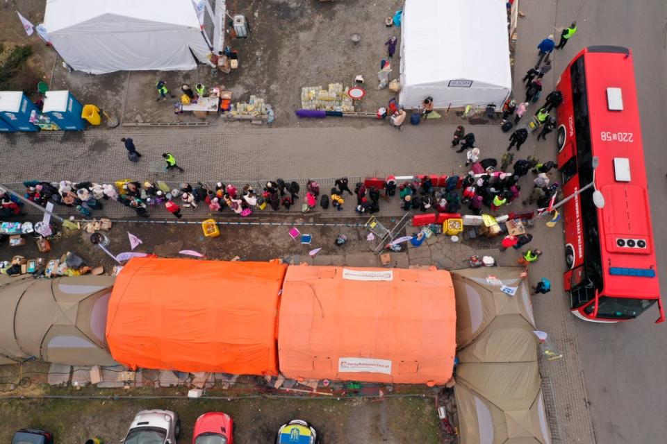 An aerial view of refugees queuing for transport at the border crossing at Medyka, Poland (AP) (AP)