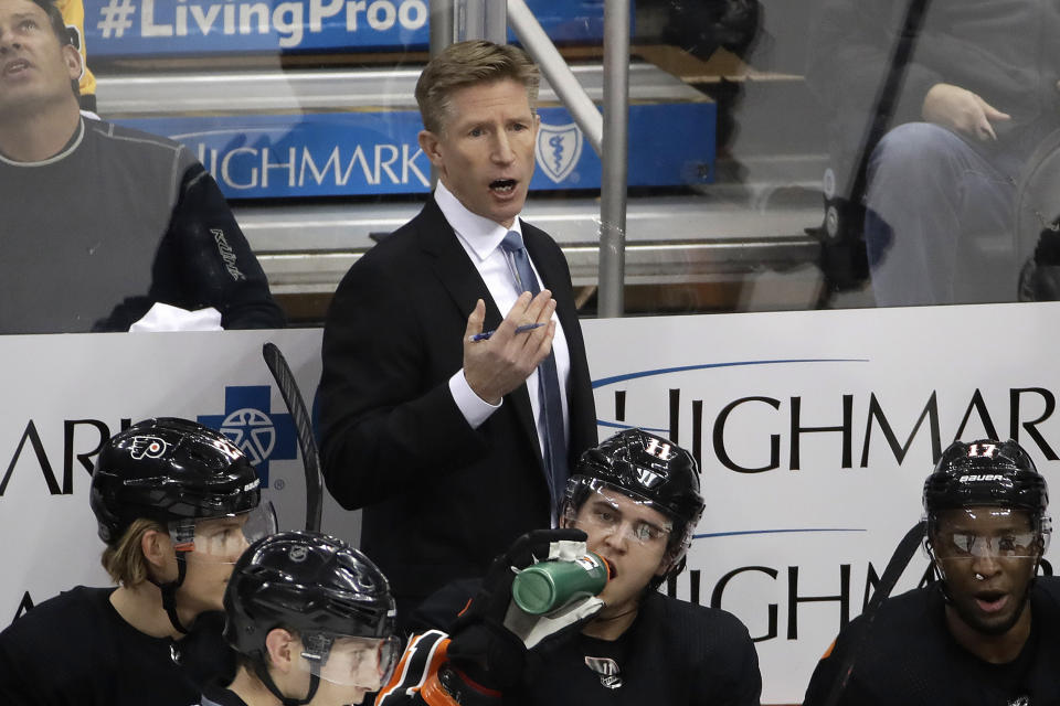 FILE - Philadelphia Flyers head coach Dave Hakstol gives instructions during the first period of an NHL hockey game against the Pittsburgh Penguins in Pittsburgh, in this Saturday, Dec. 1, 2018, file photo. The Seattle Kraken hired Dave Hakstol on Thursday, June 24, 2021, as head coach of the expansion franchise that will begin its first NHL season in the fall. It’s his second NHL head-coaching job after three plus seasons with the Philadelphia Flyers from 2015-19. (AP Photo/Gene J. Puskar, File)