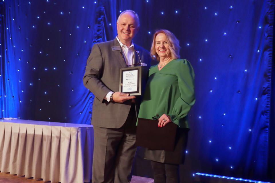 Andy Marshall, President and CEO of FirstBank Southwest, presents April Johansson, the Amarillo Globe-News Woman of the Year for 2023 at a ceremony held at the Amarillo Civic Center on Thursday night.