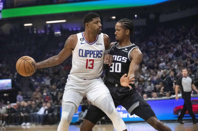 Los Angeles Clippers guard Paul George (13) is guarded by Sacramento Kings forward KZ Okpala.