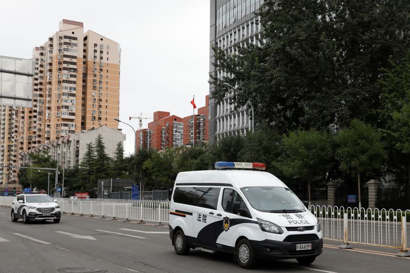 Police van leaves Beijing No. 2 Intermediate People's Court