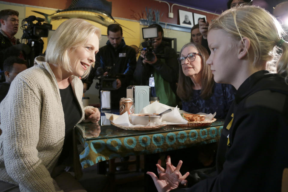 U.S. Sen. Kirsten Gillibrand, D-N.Y., sits down for a chat with Jeanette Hopkins, center, and Chloe McClure, right, at the Pierce Street Coffee Works cafe' in Sioux City, Iowa, Friday, Jan. 18, 2019. Sen. Gillibrand is on a weekend visit to Iowa, after announcing that she is forming an exploratory committee to run for President of the United States in 2020. (AP Photo/Nati Harnik)