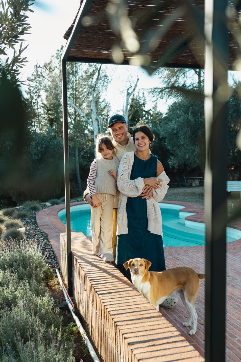 Family outside by pool.