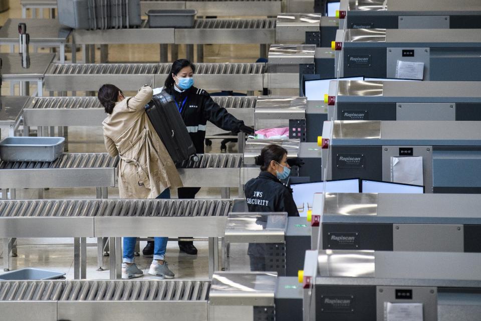 Members of security wear facemasks inside the high-speed train station connecting Hong Kong to mainland China during a public holiday in celebration of the Lunar New Year in Hong Kong on January 28, 2020, as a preventative measure following a virus outbreak which began in the Chinese city of Wuhan. - China on January 28 urged its citizens to postpone travel abroad as it expanded unprecedented efforts to contain a viral outbreak that has killed 106 people and left other governments racing to pull their nationals from the contagion's epicentre. (Photo by Anthony WALLACE / AFP) (Photo by ANTHONY WALLACE/AFP via Getty Images)