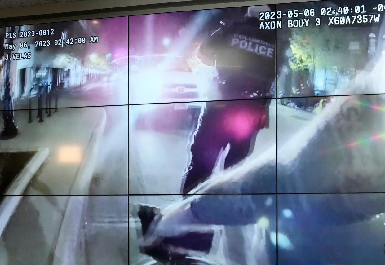A still photo taken from a Columbus police body cam video released Monday afternoon shows officers responding to gunfire early Saturday morning in the 600 block of North High Street in the Short North.  Ten people were wounded, police said, including a suspected gunman who  was taken into custody.