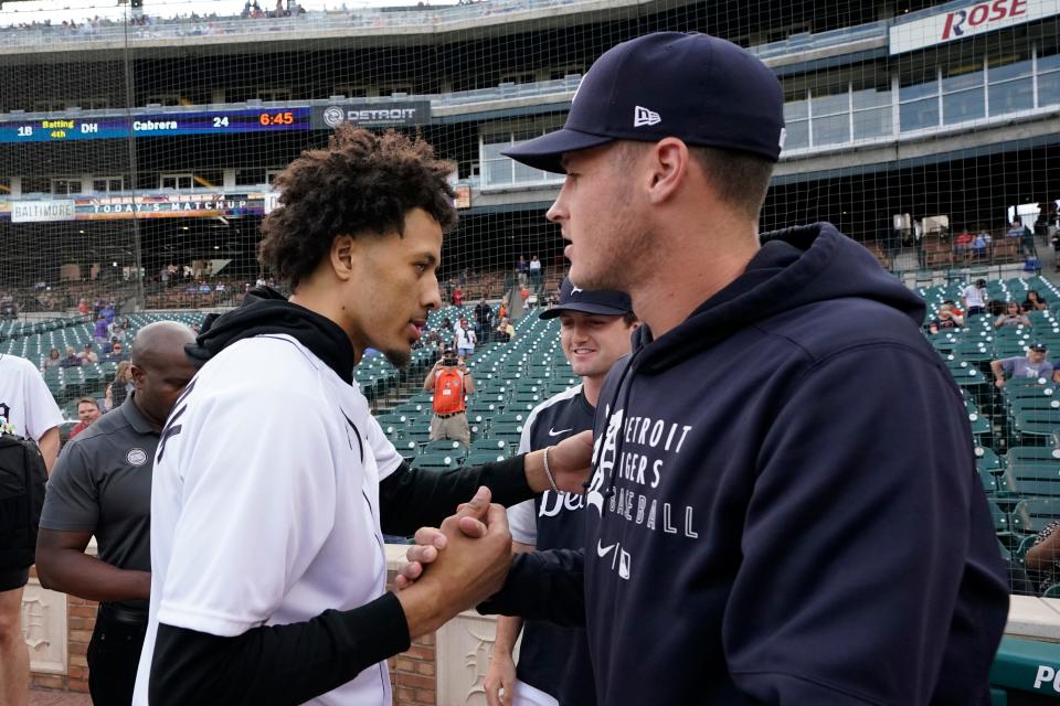 Detroit Pistons' Cade Cunningham, left, the first overall selection in the NBA basketball draft, meets with Detroit Tigers pitchers Matt Manning, right, and Casey Mize, center, before throwing out the ceremonial first pitch at the baseball game between the Tigers and the Baltimore Orioles, on Friday, July 30, 2021 in Detroit.