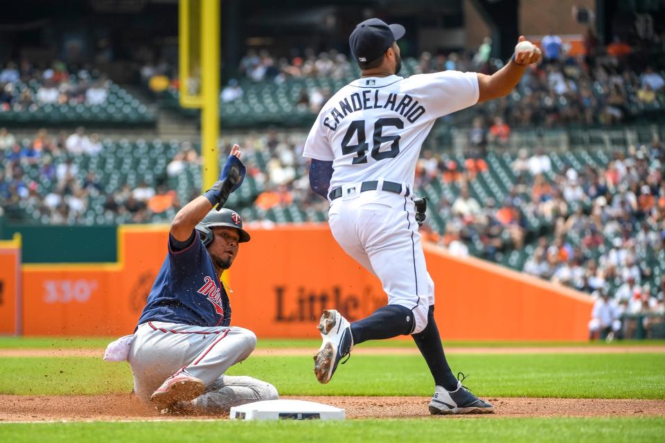 Luis Arraez #2 of the Minnesota Twins is out at third as Jeimer Candelario #46 of the Detroit Tigers throws to Jonathan Schoop #7 of the Detroit Tigers at first during the top of the third inning at Comerica Park on July 18, 2021 in Detroit, Michigan.