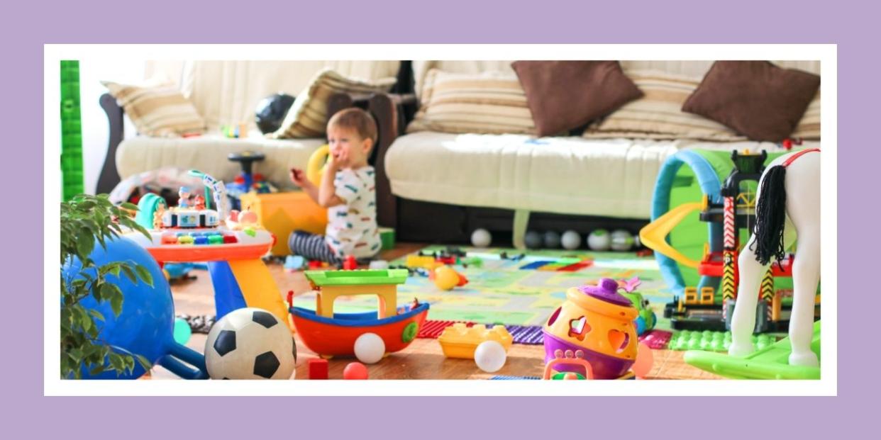 toddler in the middle of a messy living room