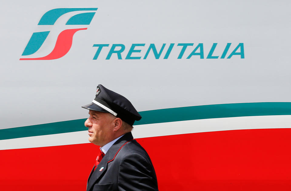 A Trenitalia's conductor walks next to Frecciargento's train at the Vatican railway station in Vatican May 28, 2016. REUTERS/Alessandro Bianchi