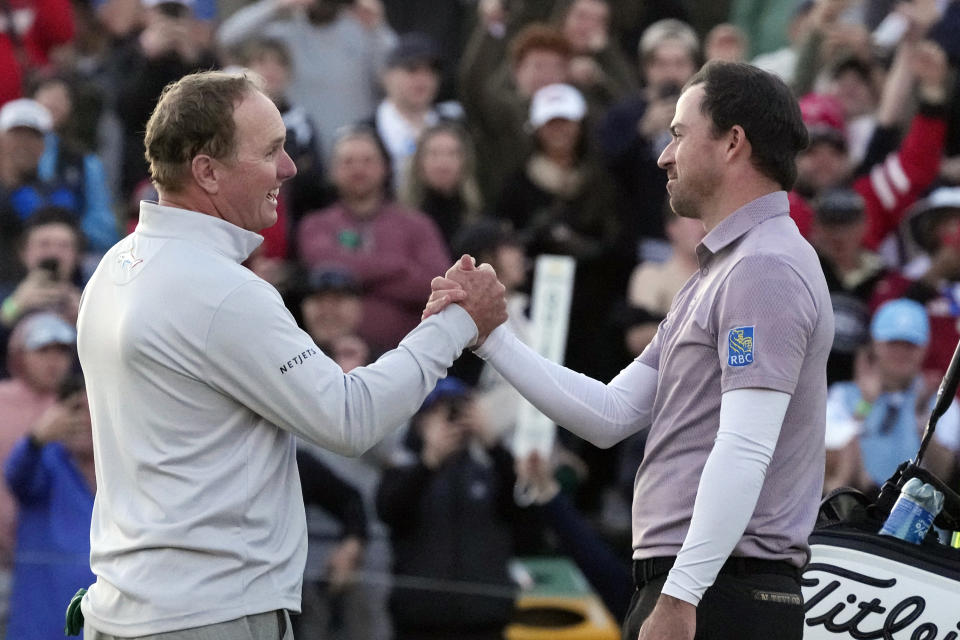 Nick Taylor, right, of Canada, is congratulated by Charley Hoffman, left, after winning on the second playoff hole at the 18th green after the Phoenix Open golf tournament Sunday, Feb. 11, 2024, in Scottsdale, Ariz. (AP Photo/Ross D. Franklin)