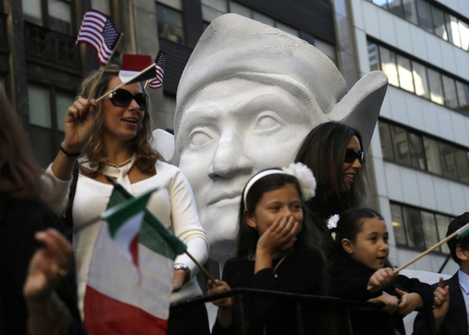 FILE - In this Oct. 12, 2015, file photo, participants in New York's Columbus Day Parade ride a float with a large bust of Columbus. The image and story Christopher Columbus, the 15th Century navigator who began European incursions into the Americas, have changed in the U.S. over decades. (AP Photo/Seth Wenig)