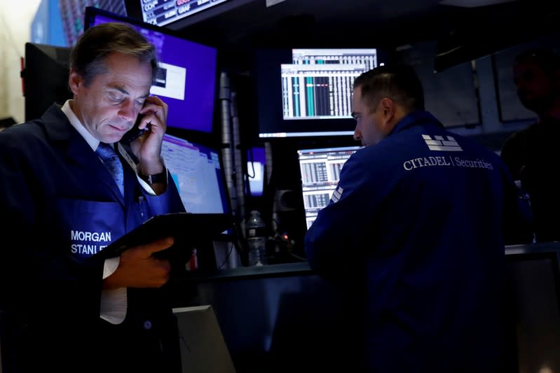 Traders work on the floor at the NYSE in New York