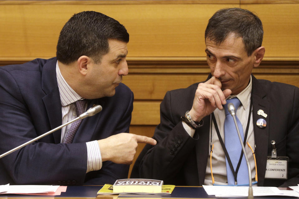 Survivor of sex abuse Francesco Zanardi, right, listens to Mark Rozzi, Democratic member of the Pennsylvania House of Representatives, during a press conference at the Italian Lower Chamber press hall in Rome, Thursday, Feb. 21, 2019. Pope Francis opened a landmark sex abuse prevention summit Thursday by warning senior Catholic figures that the faithful are demanding concrete action against predator priests and not just words of condemnation. (AP Photo/Gregorio Borgia)