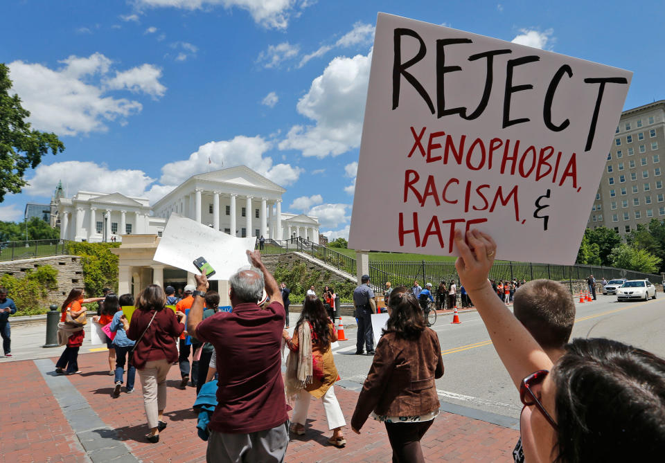 <p>Protesters hold signs and march in front of the State Capitol across the street from the US 4th Circuit Court of Appeals in Richmond, Va., Monday, May 8, 2017. The court will examine a ruling that blocks the administration from temporarily barring new visas for citizens of Iran, Libya, Somalia, Sudan, Syria and Yemen. It’s the first time an appeals court will hear arguments on the revised travel ban, which is likely destined for the U.S. Supreme Court. (AP Photo/Steve Helber) </p>