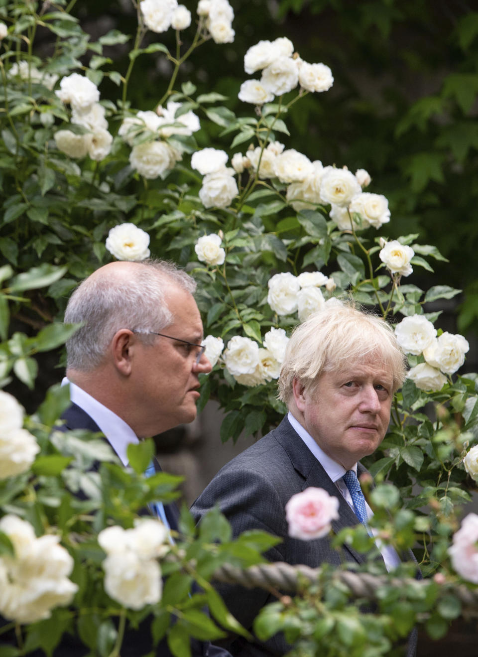 Britain's Prime Minister Boris Johnson, right, walks with Australian Prime Minister Scott Morrison after their meeting, in the garden of 10 Downing Streeet, in London, Tuesday June 15, 2021. Britain and Australia have agreed on a free trade deal that will be released later Tuesday, Australian Trade Minister Dan Tehan said. (Dominic Lipinski/Pool Photo via AP)