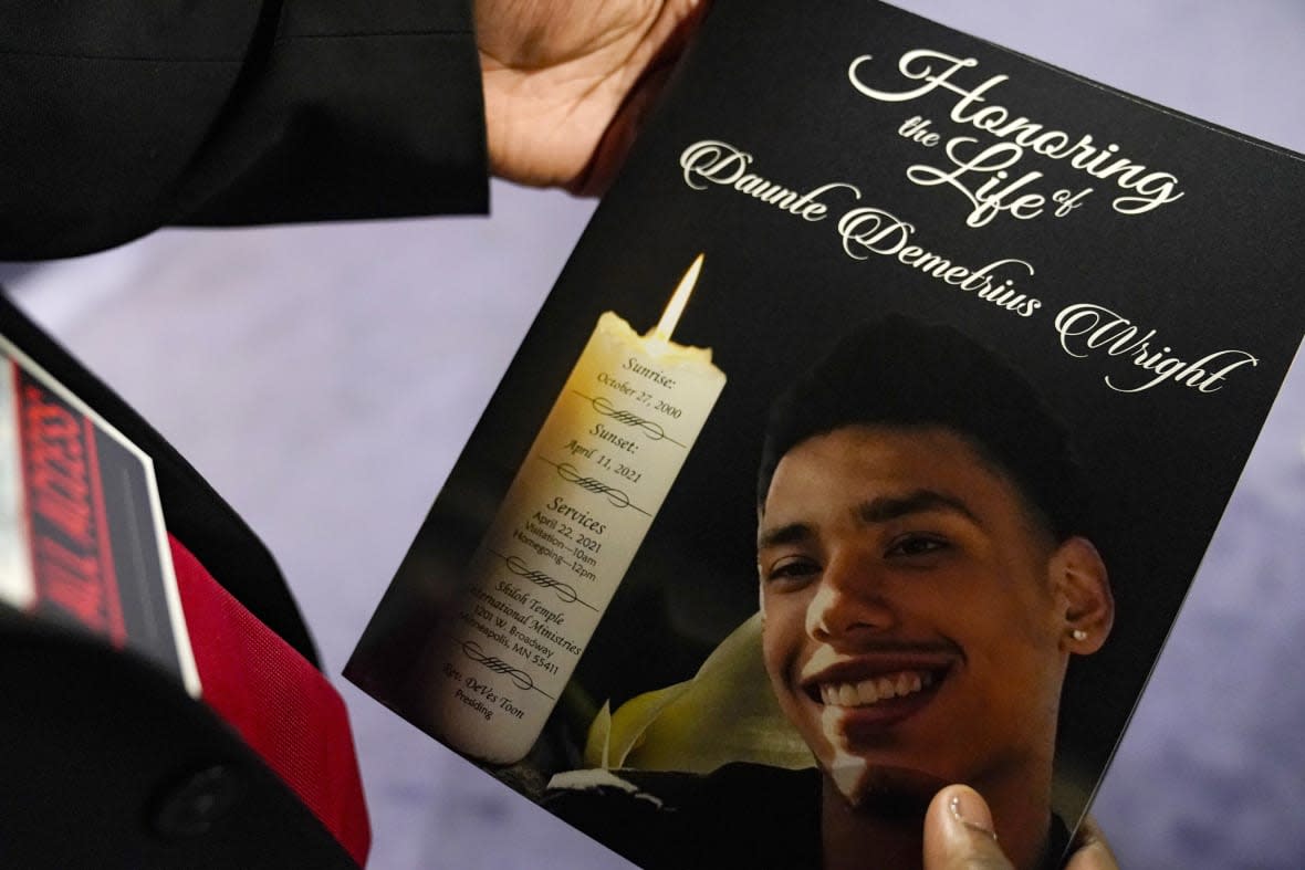 FILE – A mourner holds a program for the funeral services of Daunte Wright at Shiloh Temple International Ministries in Minneapolis, April 22, 2021. Former Brooklyn Center Police Officer Kim Potter is scheduled to be released from prison on Monday, April 24, 2023. She was sentenced to two years in prison in February 2022 after being convicted of manslaughter in the death of 20-year-old Daunte Wright. She shot Wright and said she confused her Taser with her handgun. (AP Photo/John Minchillo, Pool, File)