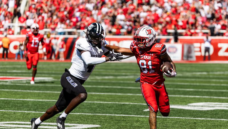 Utah Utes wide receiver Mikey Matthews (81) runs the ball down the field with Weber State Wildcats cornerback Abraham Williams (4) on defense during their football game at Rice-Eccles Stadium in Salt Lake City on Saturday, Sept. 16, 2023.