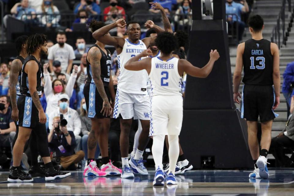 Kentucky’s Oscar Tshiebwe (34) and Sahvir Wheeler (2) celebrated during the first half Saturday. Tshiebwe finished with 16 points and 12 rebounds. Wheeler ended up with 26 points and eight assists.