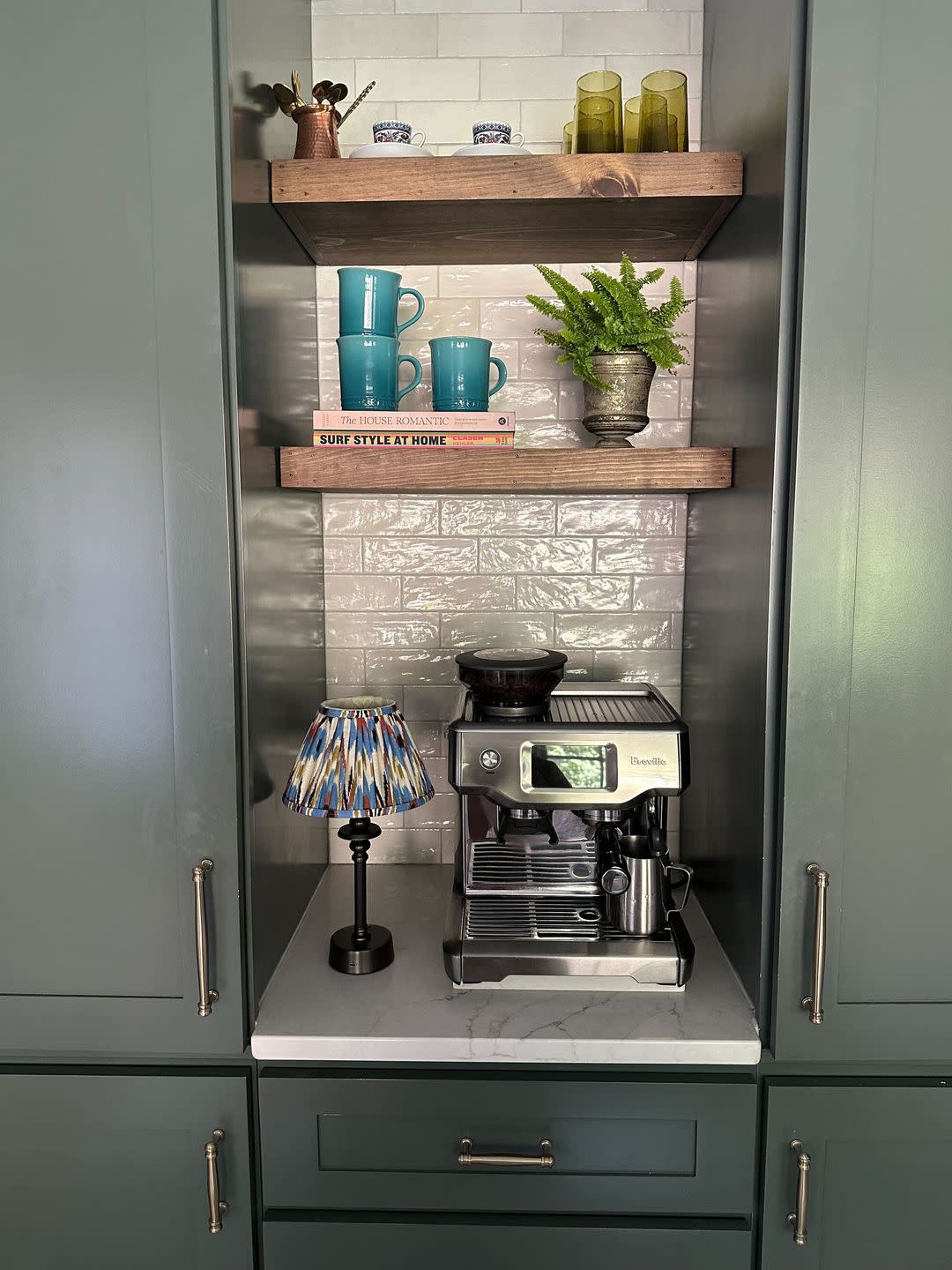 a kitchen with a coffee maker and shelves