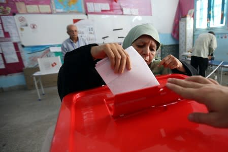 Woman casts her vote in a polling station during presidential election in Tunis