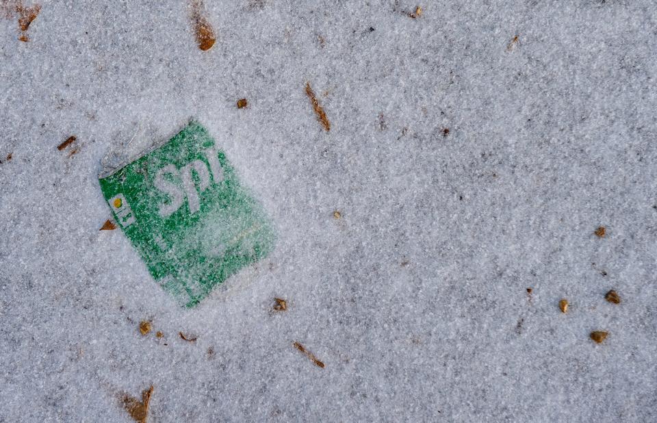 A sprite can is buried under ice.