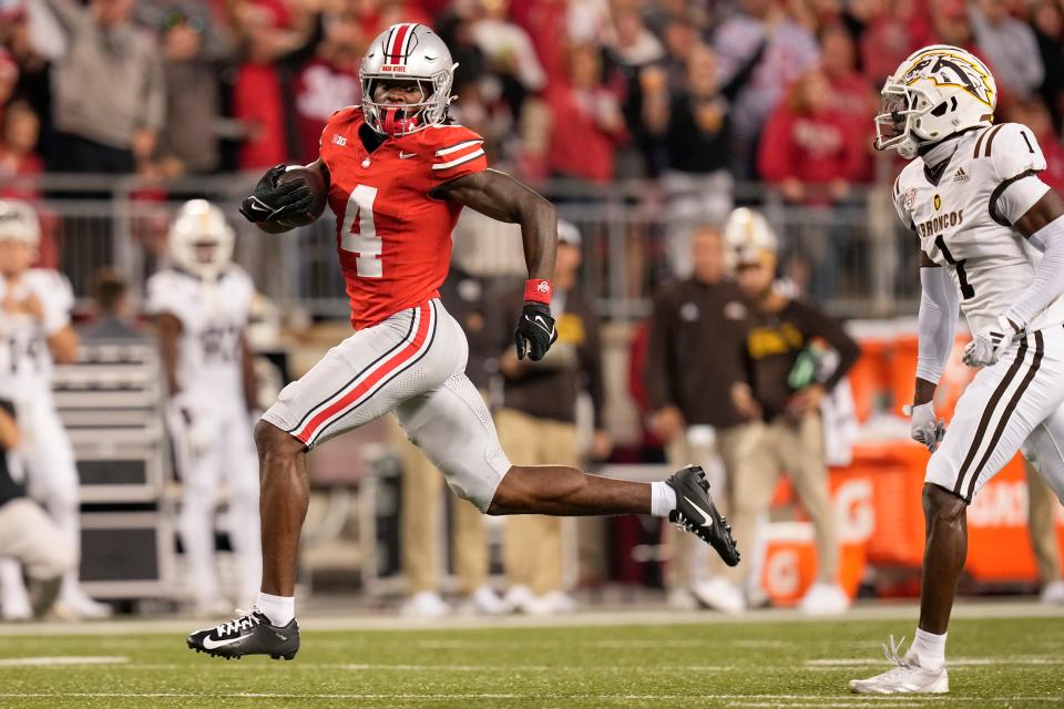 Sep 7, 2024; Columbus, Ohio, USA; Ohio State Buckeyes wide receiver Jeremiah Smith (4) runs for a touchdown past Western Michigan Broncos cornerback Bilhal Kone (1) after making a catch during the first half of the NCAA football game against the Western Michigan Broncos at Ohio Stadium.