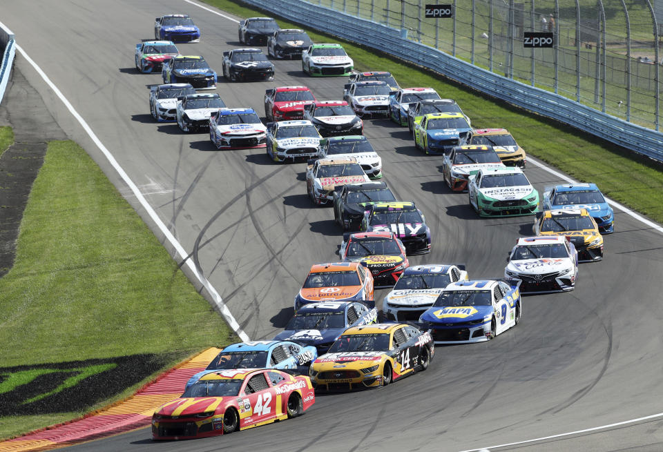 The field of drivers head into Turn 1 after a restart following a yellow caution flag during a NASCAR Cup Series auto race at Watkins Glen International, Sunday, Aug. 4, 2019, in Watkins Glen, N.Y. (AP Photo/John Munson)